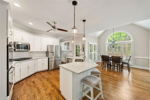 10000 Groomsbridge Rd, Johns Creek, GA 30022 - kitchen featuring appliances with stainless steel finishes, a sink, ceiling fan, white cabinetry, and lofted ceiling