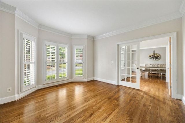 10000 Groomsbridge Rd, Johns Creek, GA 30022 - spare room featuring wood finished floors, crown molding, baseboards, and a chandelier