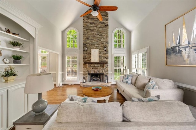 10000 Groomsbridge Rd, Johns Creek, GA 30022 - living area featuring a ceiling fan, wood finished floors, high vaulted ceiling, and a stone fireplace