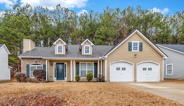 cape cod-style house featuring an attached garage, a chimney, concrete driveway, and roof with shingles