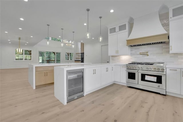 3903 Indian Shoals Rd SE, Bethlehem, GA 30620 - kitchen featuring double oven range, beverage cooler, custom exhaust hood, a peninsula, and light countertops