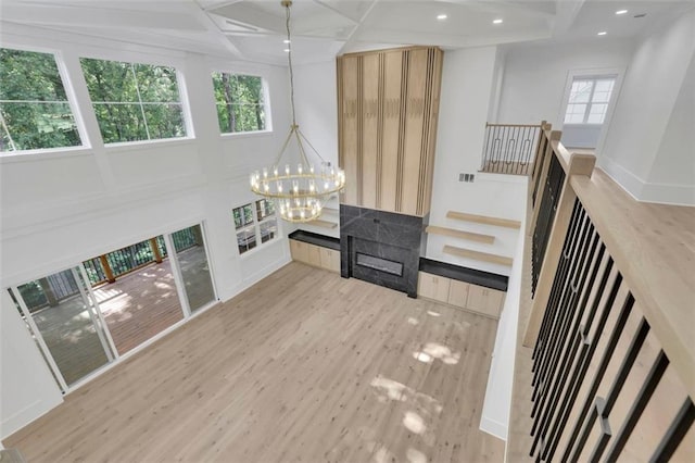 3903 Indian Shoals Rd SE, Bethlehem, GA 30620 - unfurnished living room with a chandelier, wood finished floors, coffered ceiling, beam ceiling, and recessed lighting