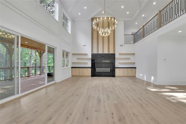 3903 Indian Shoals Rd SE, Bethlehem, GA 30620 - unfurnished living room featuring a high ceiling, wood finished floors, a chandelier, beamed ceiling, and recessed lighting