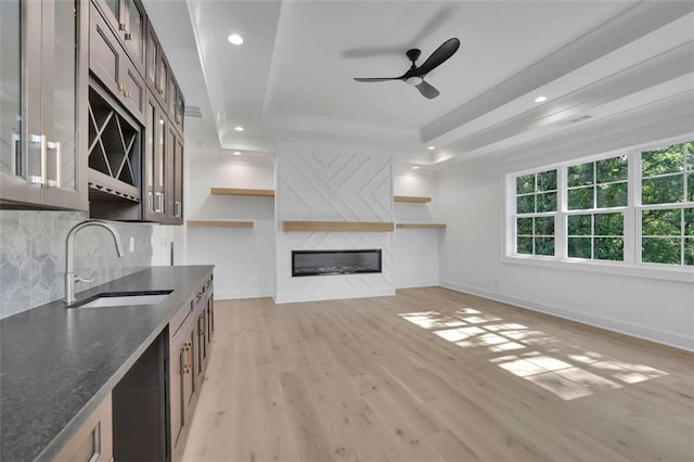 3903 Indian Shoals Rd SE, Bethlehem, GA 30620 - unfurnished living room with a tray ceiling, ceiling fan, light wood-type flooring, recessed lighting, and a large fireplace