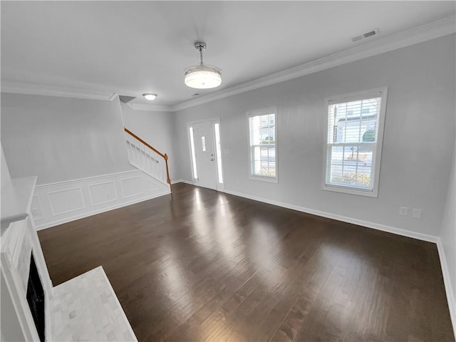 unfurnished living room featuring dark wood-style floors, visible vents, stairway, ornamental molding, and baseboards