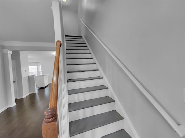 stairway with visible vents, baseboards, and wood finished floors