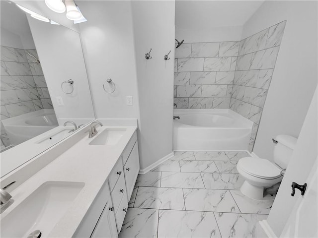 bathroom with marble finish floor, a sink, and toilet