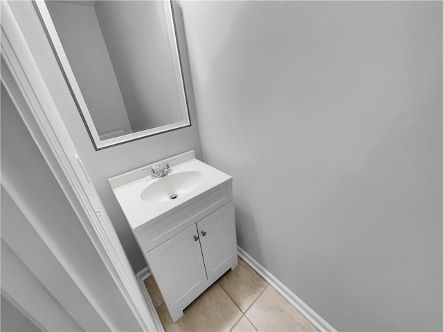 bathroom featuring vanity, baseboards, and tile patterned floors