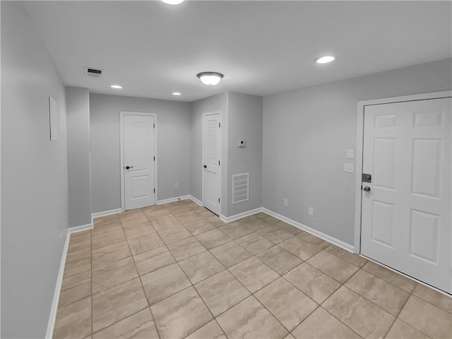 spare room featuring recessed lighting, visible vents, and baseboards