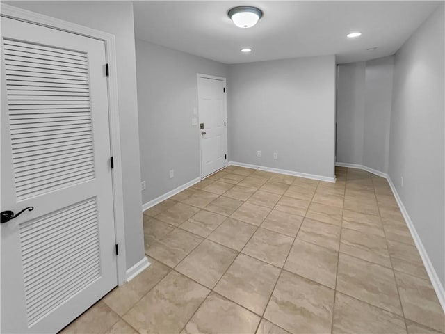 empty room with light tile patterned floors, recessed lighting, and baseboards