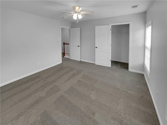 unfurnished bedroom with a closet, carpet flooring, visible vents, and baseboards