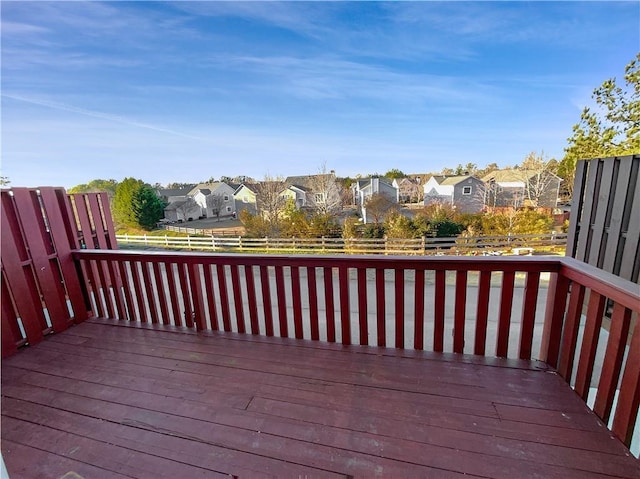 wooden deck with a residential view and fence