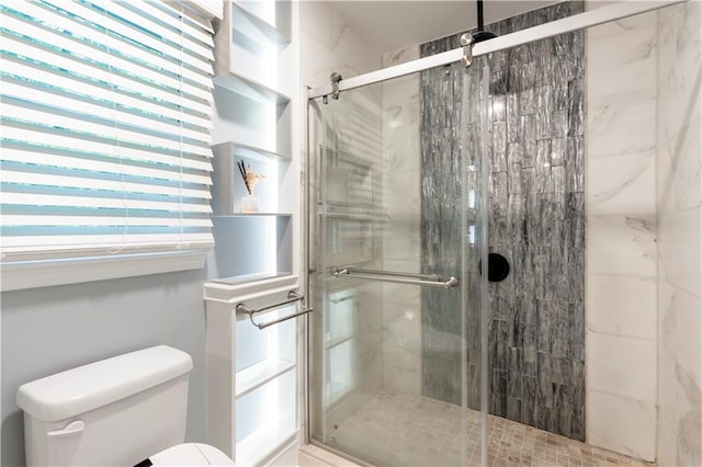 full bath featuring toilet and a stall shower