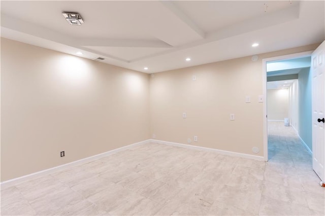 spare room featuring recessed lighting and baseboards