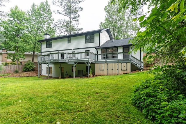 rear view of house featuring a wooden deck, a chimney, central AC, and stairs