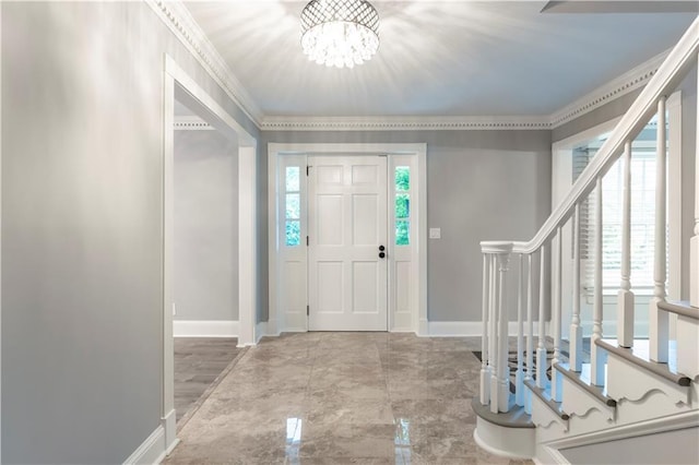 entrance foyer featuring stairs, baseboards, a chandelier, and ornamental molding