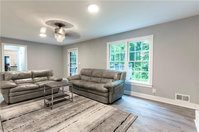 living area with baseboards and wood finished floors