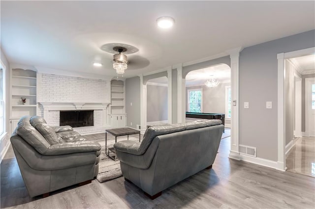 living area featuring baseboards, built in features, wood finished floors, pool table, and healthy amount of natural light