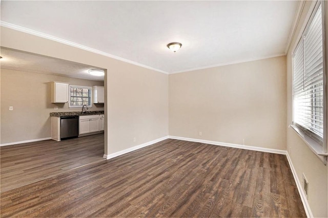 empty room featuring dark wood-type flooring and crown molding