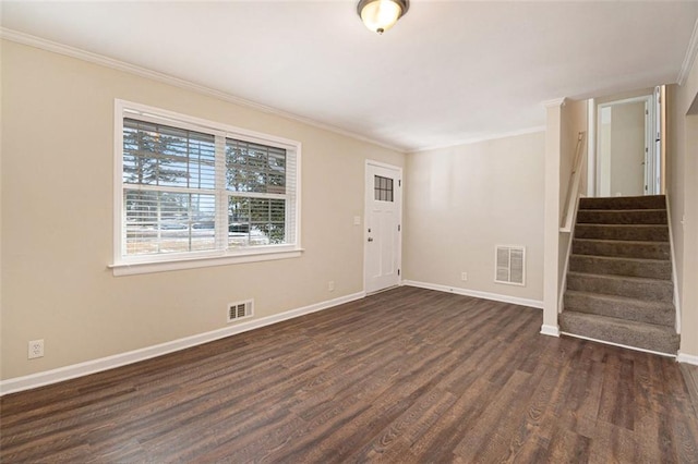 foyer with ornamental molding and dark wood-type flooring