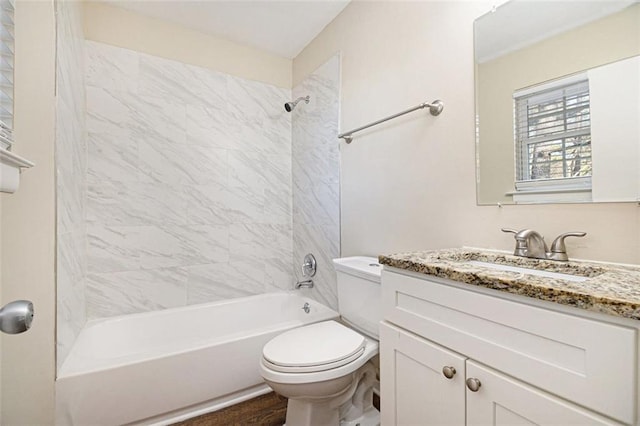 full bathroom with toilet, tiled shower / bath combo, hardwood / wood-style floors, and vanity