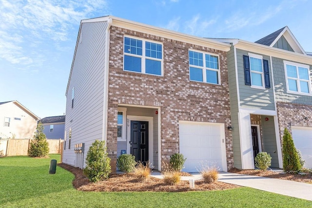 townhome / multi-family property with a garage and a front yard