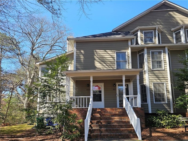 view of front of property with stairs and a porch