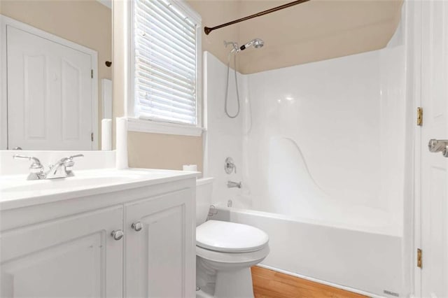 full bathroom with vanity, toilet, tub / shower combination, and hardwood / wood-style floors