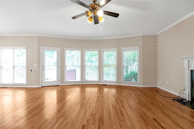 unfurnished living room with crown molding, ceiling fan, a fireplace, and light hardwood / wood-style floors