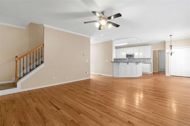 unfurnished living room with ceiling fan, ornamental molding, and light hardwood / wood-style floors