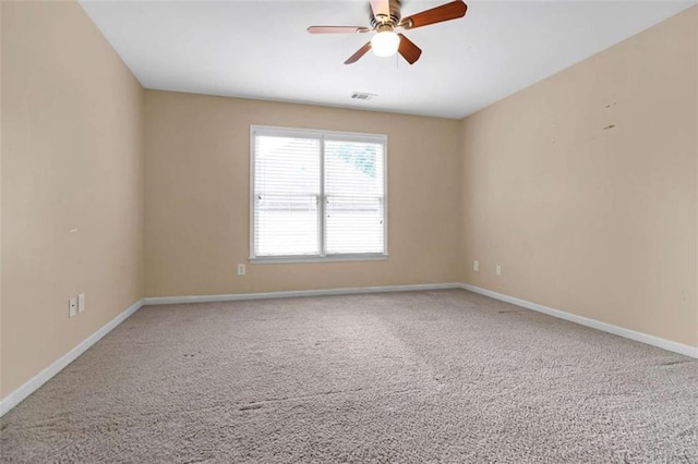 carpeted spare room with ceiling fan