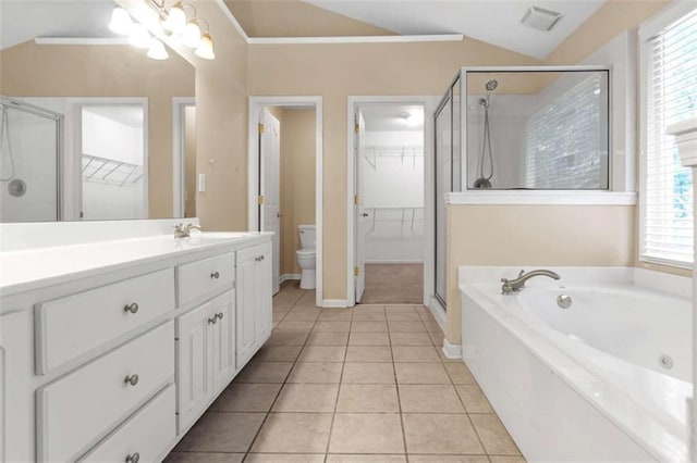 full bathroom featuring tile patterned flooring, plenty of natural light, toilet, and vaulted ceiling