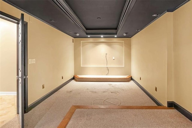 spare room featuring light carpet and a tray ceiling