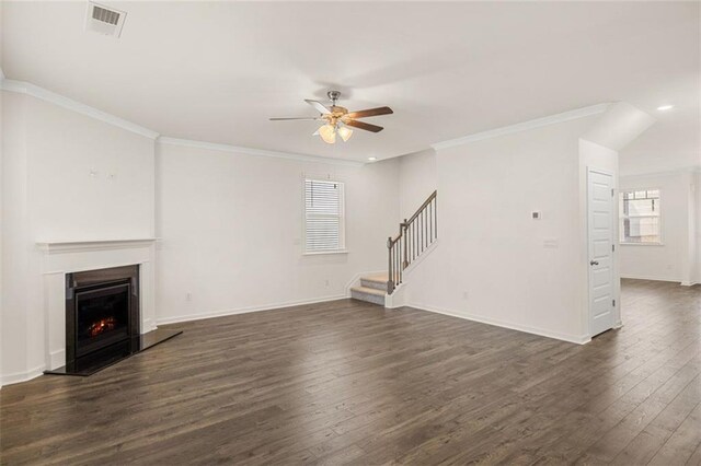 1159 Blue Juniper Cir, Loganville, GA 30052 - unfurnished living room featuring a ceiling fan, dark wood-type flooring, stairs, plenty of natural light, and ornamental molding