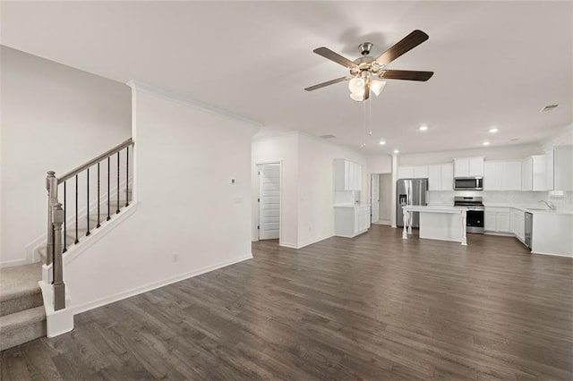 1159 Blue Juniper Cir, Loganville, GA 30052 - unfurnished living room with ceiling fan, dark wood-type flooring, recessed lighting, stairs, and baseboards