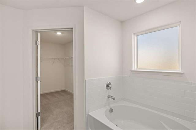 1159 Blue Juniper Cir, Loganville, GA 30052 - full bath featuring a garden tub, a walk in closet, recessed lighting, and baseboards