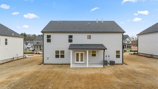 1159 Blue Juniper Cir, Loganville, GA 30052 - back of house with a patio, a shingled roof, and a residential view