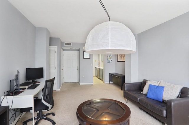 home office featuring visible vents, baseboards, and light colored carpet