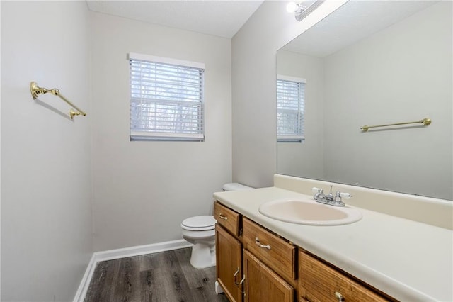 bathroom featuring hardwood / wood-style flooring, vanity, and toilet