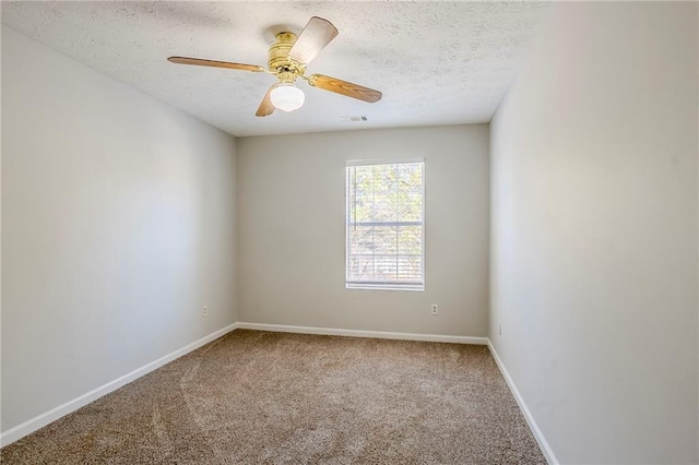 carpeted empty room featuring ceiling fan and a textured ceiling