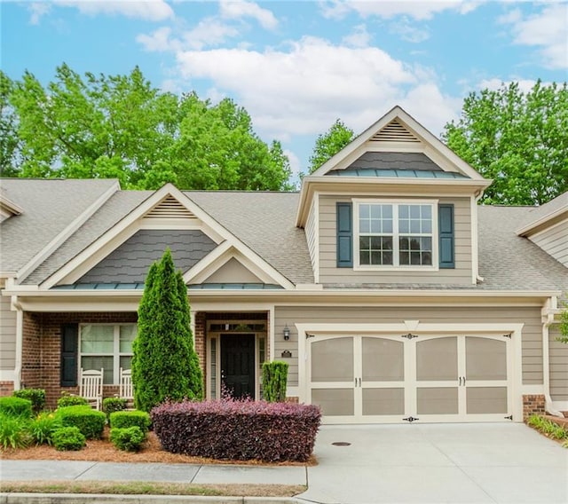 1555 Water Vista Ct Unit 4102, Cumming, GA 30041 - craftsman house featuring a shingled roof, driveway, brick siding, an attached garage, and covered porch
