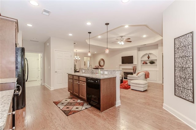 1555 Water Vista Ct Unit 4102, Cumming, GA 30041 - kitchen with black appliances, ceiling fan, light wood-style floors, a fireplace, and open floor plan