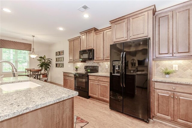 1555 Water Vista Ct Unit 4102, Cumming, GA 30041 - kitchen with black appliances, a sink, tasteful backsplash, light wood-style flooring, and recessed lighting