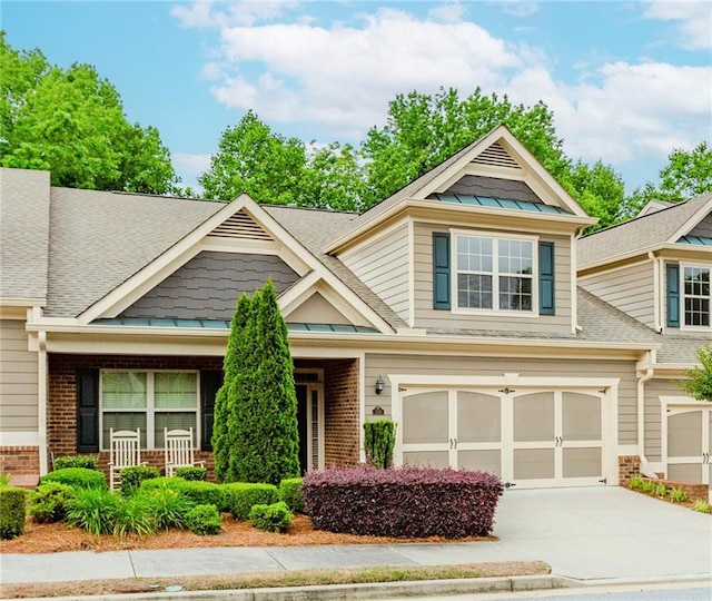 1555 Water Vista Ct Unit 4102, Cumming, GA 30041 - craftsman-style home with brick siding, a standing seam roof, concrete driveway, and a shingled roof