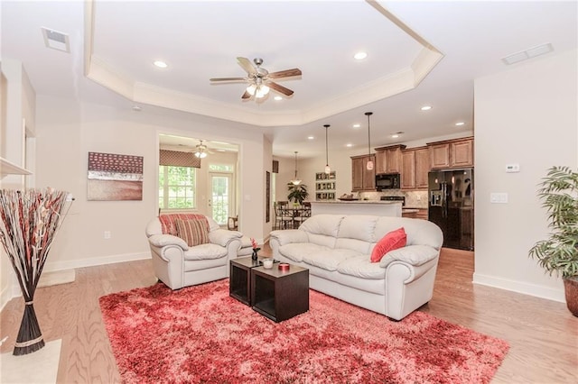 1555 Water Vista Ct Unit 4102, Cumming, GA 30041 - living room featuring a tray ceiling, a ceiling fan, light wood finished floors, crown molding, and recessed lighting