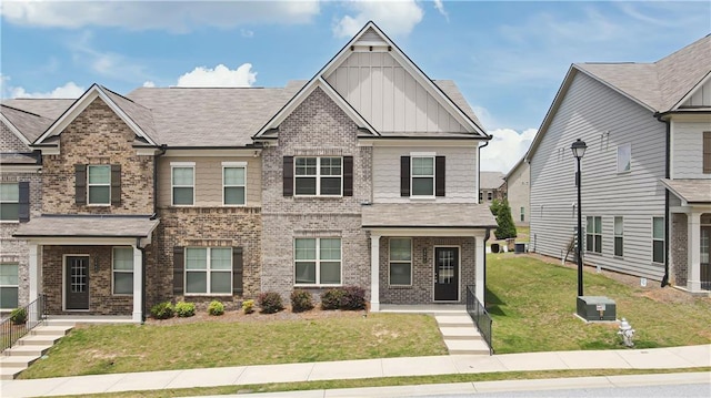2692 Pearl Ridge Trce, Buford, GA 30519 - view of front of house featuring board and batten siding, brick siding, and a front lawn