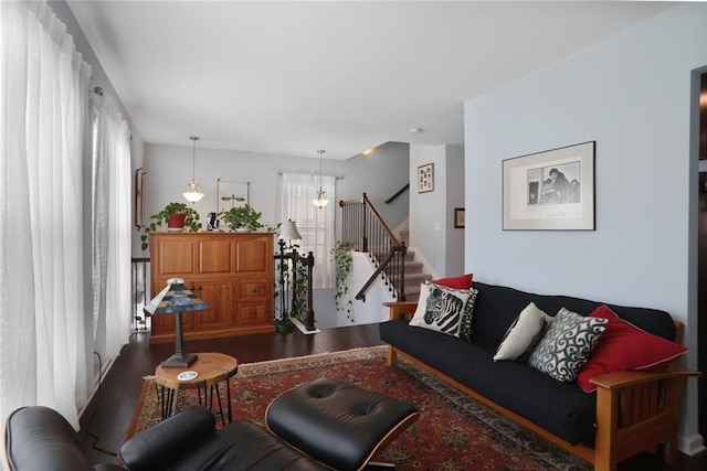 living room with stairway and wood finished floors