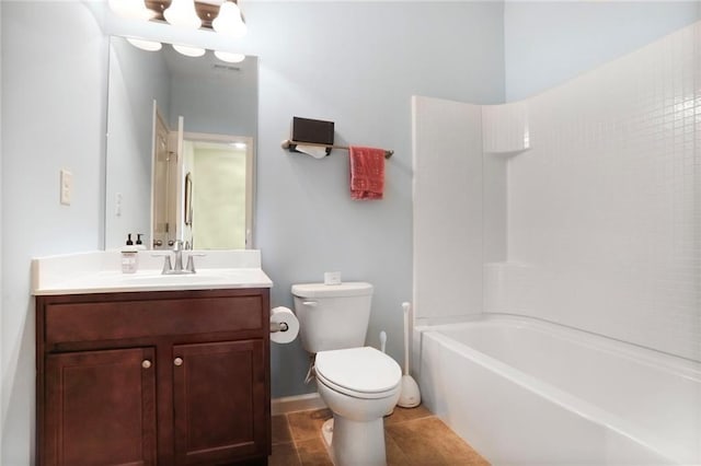 bathroom featuring tile patterned floors, toilet, baseboards, bathing tub / shower combination, and vanity