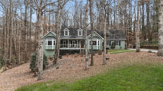 cape cod-style house featuring a porch