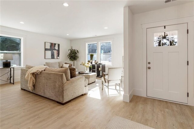 unfurnished living room featuring light hardwood / wood-style flooring and a chandelier